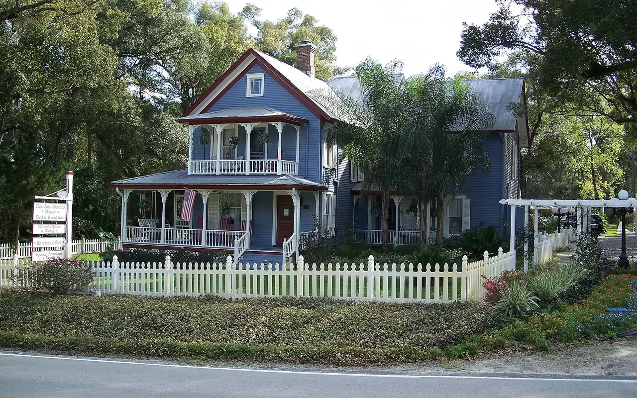 Older wood-frame home under live oaks in the historic district of Bartow, Florida